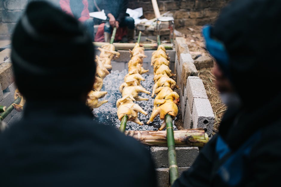 Spit-roasting chickens over coals in Lạng Sơn, Vietnam, showcasing local culinary tradition.