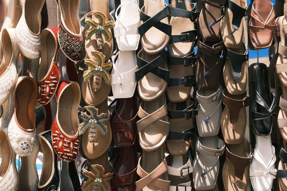 Vibrant arrangement of traditional and modern footwear in a Bengaluru market stall.