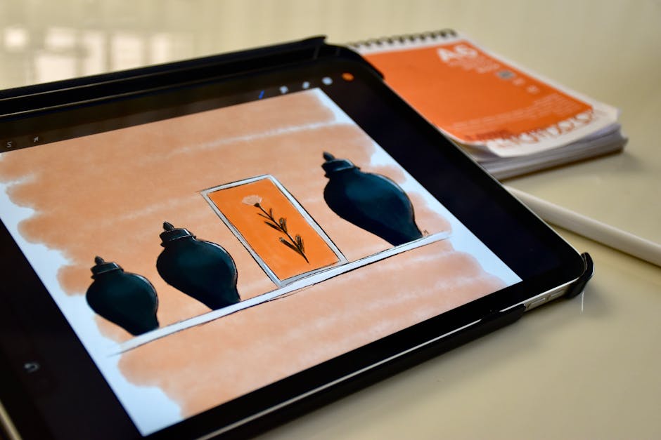 A digital sketch of vases and a flower displayed on a tablet with a stylus and notebook nearby.