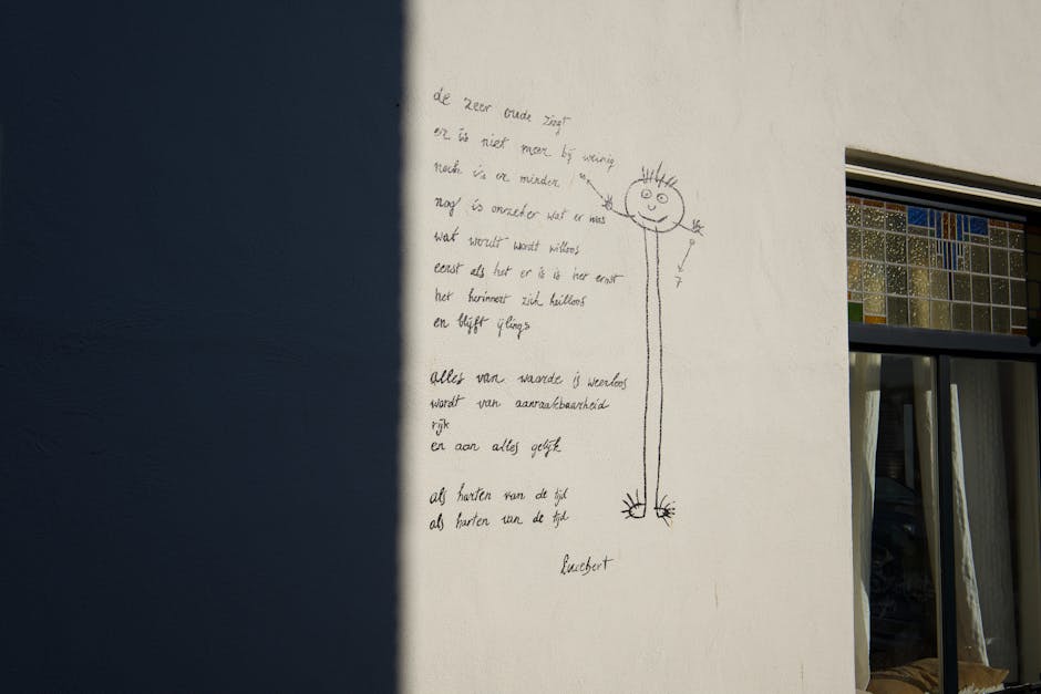 Graffiti drawing with poem on a building wall with stained glass window.